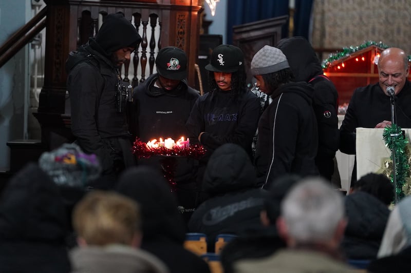 People lighting candles during a vigil at St Mary Magdalene church