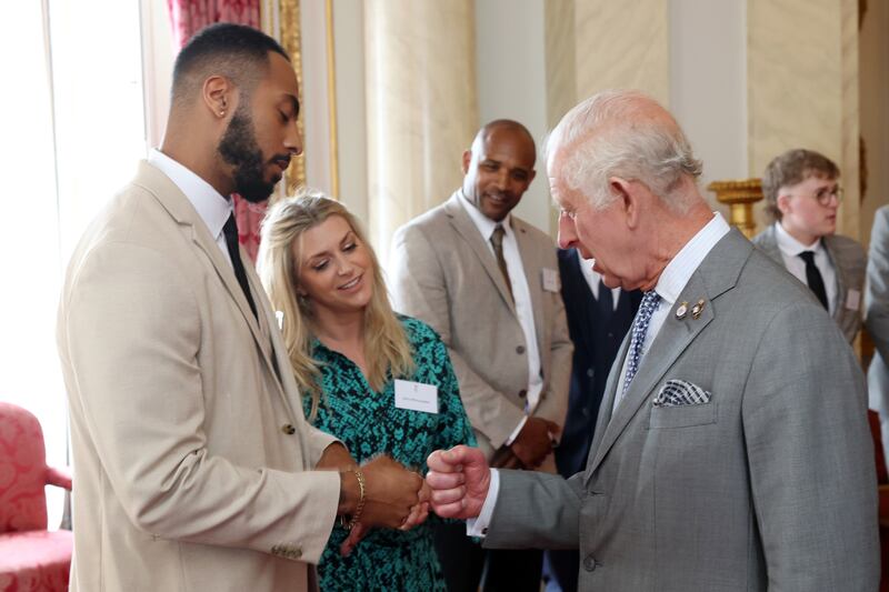 The King fist-bumping Tyler West during a reception for the Prince’s Trust Awards at the Palace on Wednesday