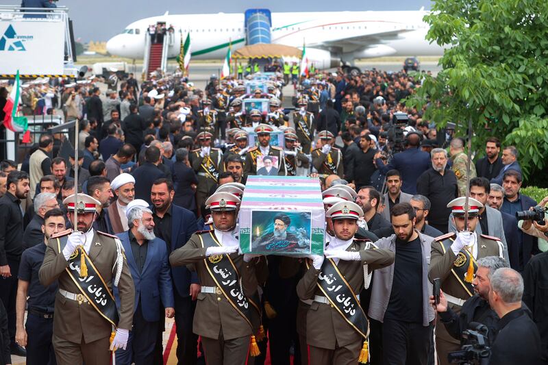 Army members carry the flag-draped coffins of President Ebrahim Raisi (Iranian Presidency Office/AP)
