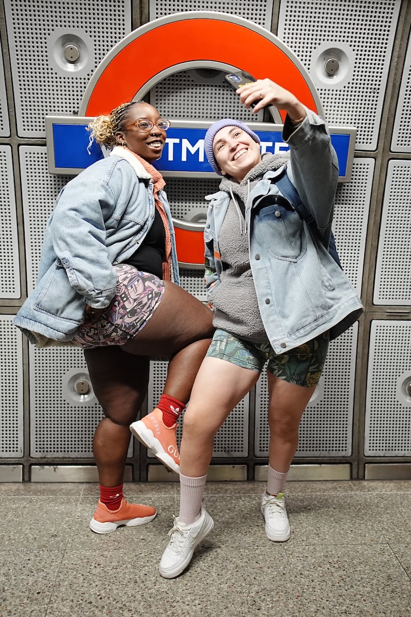 Two women take a selfie on a Tube platform