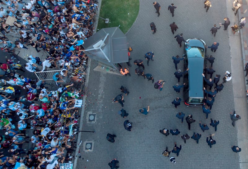 The hearse carrying the coffin of Diego Maradona leaves the government house in Buenos Aires (Mario De Fina/AP)