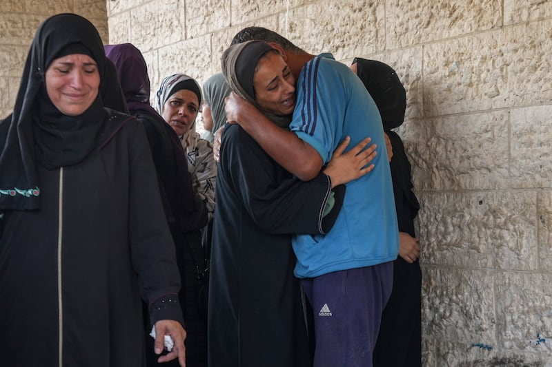 Palestinians grieve at the funeral for more than 15 people killed in an Israeli strike, at Al-Aqsa Martyrs Hospital in Deir al-Balah (AP Photo/Abdel Kareem Hana)