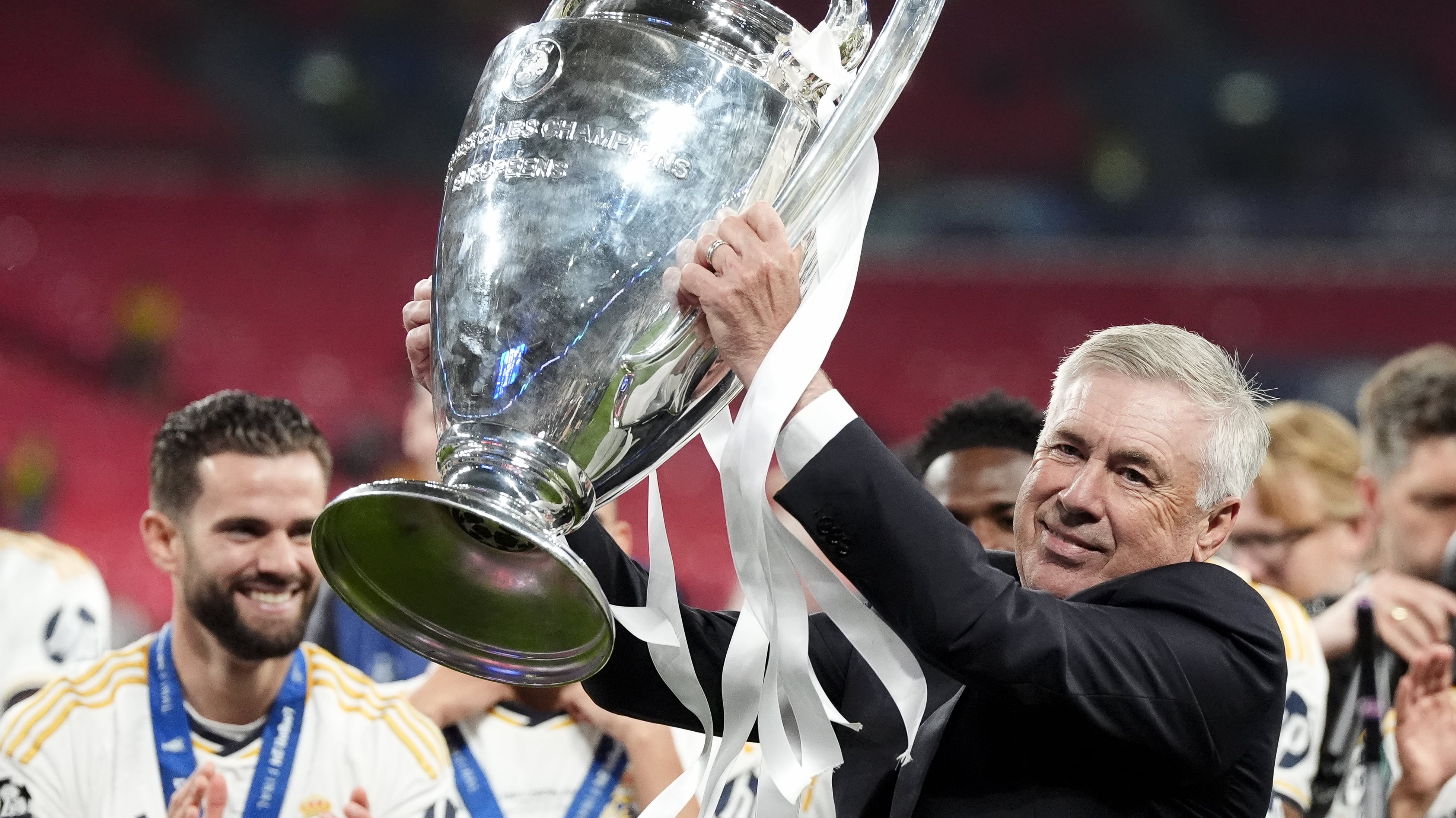 Real Madrid manager Carlo Ancelotti celebrates with the trophy after winning the Champions League final at Wembley