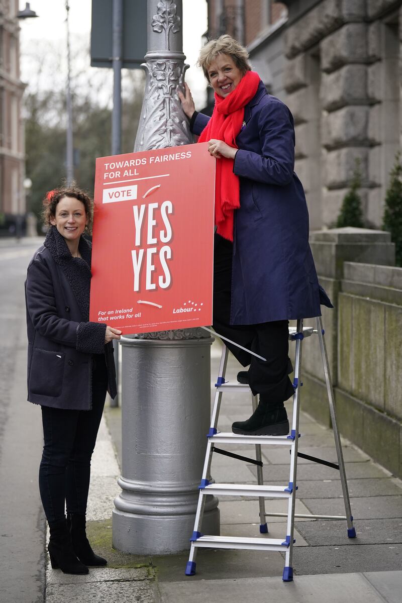 Labour’s director of elections for the Family and Care Referendum Senator Marie Sherlock (left) and party leader Ivana Bacik putting up a poster on Kildare Street in Dublin