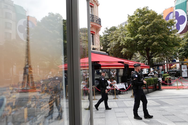 Police officers patrol Paris’s Champs-Elysees ahead of the Paralympic Games (Aurelien Morissard/AP)