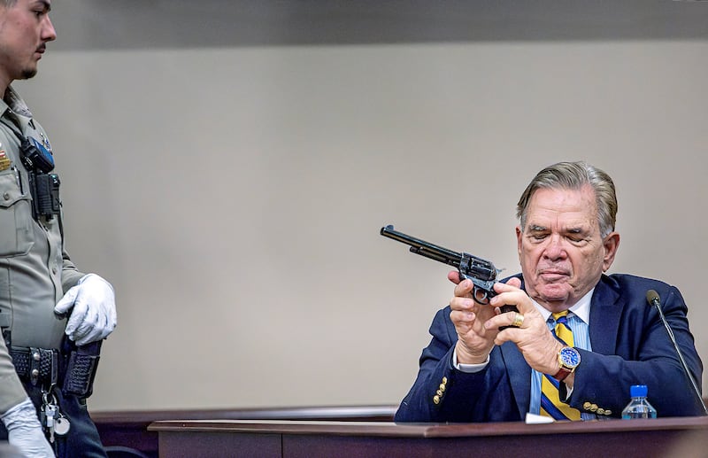 Santa Fe County Deputy Levi Abeyta, left, watches as firearms expert for the defence Frank Koucky III demonstrates how to uncock a gun like the one used on the set of the movie Rust (Jim Weber/Santa Fe New Mexican via AP, Pool)