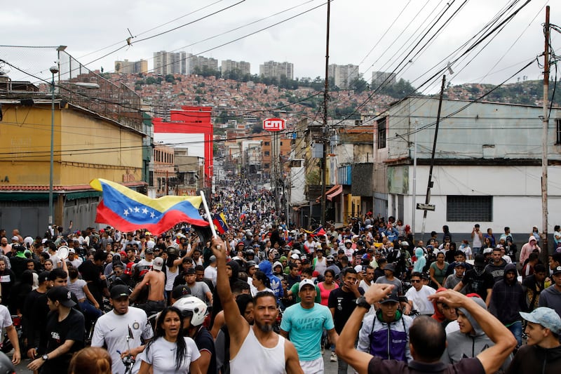 Protesters in the Catia neighbourhood of Caracas demonstrate against Venezuela’s official election results declaring President Nicolas Maduro the winner (Cristian Hernandez/AP)