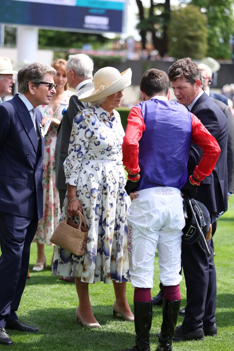 Queen Camilla (centre) with jockey Oisin Murphy, rider of her horse Handcuffed, in the Sodexo Live! Princess Margaret Stakes (Fillies’ Group 3), during the Qipco King George Day at Ascot Racecourse, Berkshire