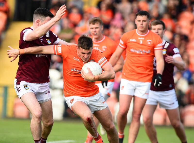 Armagh's Greg McCabe bursts through a tackle from Westmeath's James Dolan. Picture: John Merry