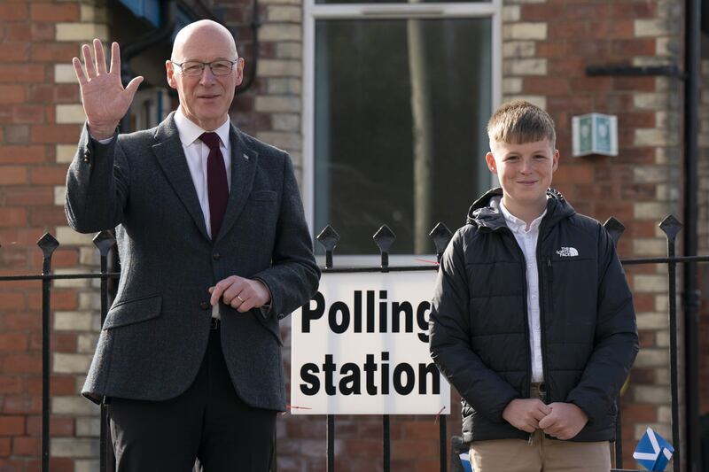 John Swinney was accompanied by his son Matthew to cast his vote at Burrelton Village Hall in Perthshire