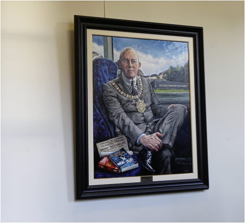 The new portrait of formerLord Mayor Arder Carson of Sinn F&eacute;in goes up in City Hall. PICTURE: HUGH RUSSELL 
