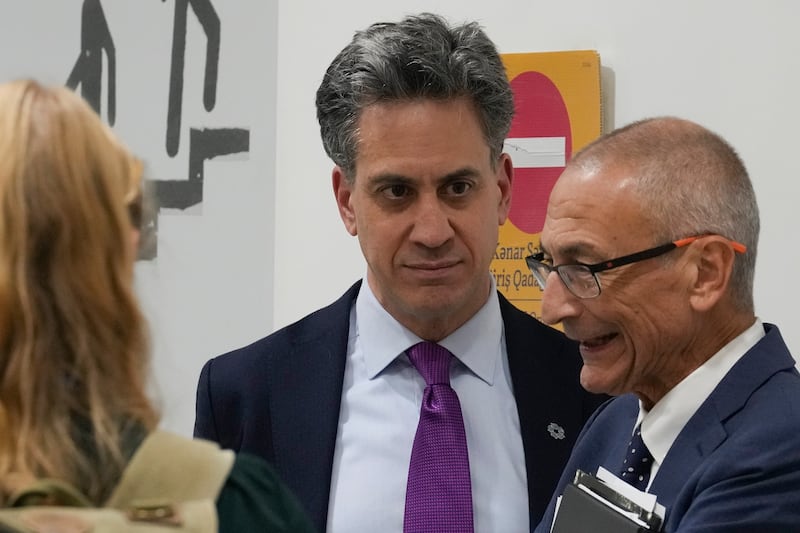 Energy Secretary Ed Miliband centre, speaking with US climate envoy John Podesta, right, at the summit (AP Photo/Rafiq Maqbool)