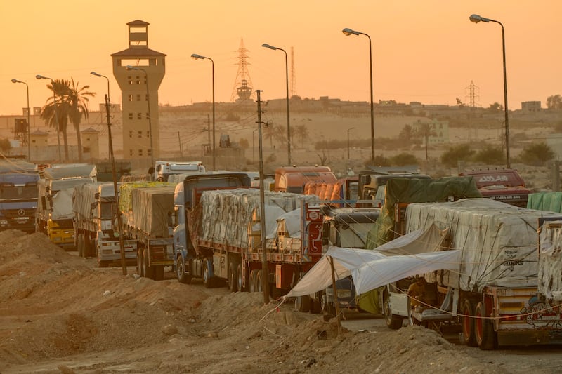 Trucks of humanitarian aids wait to cross the Rafah border (Amr Nabil/AP)