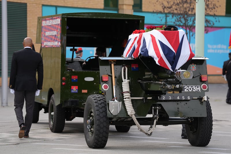 The coffin, draped in the union flag, is escorted on a gun carriage