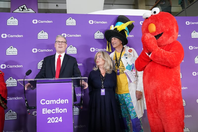 Labour leader Sir Keir Starmer (left) gives a victory speech watched by Nick the Incredible Flying Brick (second right) and Bobby ‘Elmo’ Smith (right)