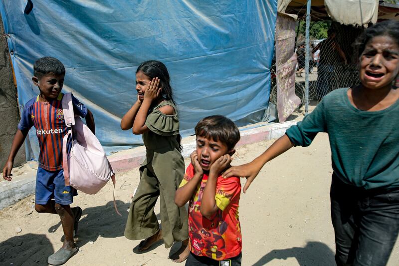 Palestinian children are evacuated from a site hit by an Israeli bombardment on Khan Younis, southern Gaza Strip (AP Photo/Jehad Alshrafi, File)