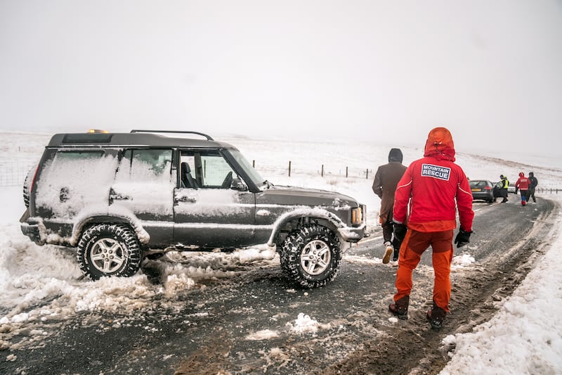 Members of a Mountain Rescue team after helping to clear cars from a snow drift near Ribblehead, in North Yorkshire