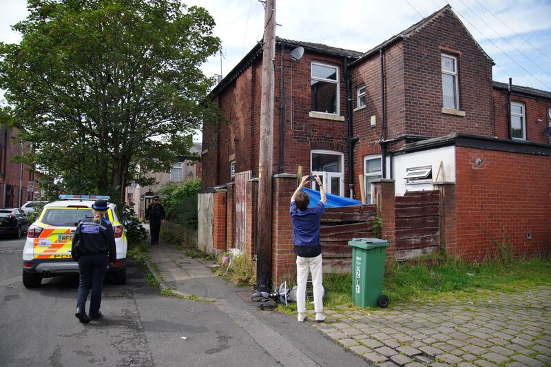 Police officers outside Donald Patience’s property in Ainsworth Road, Radcliffe in Greater Manchester