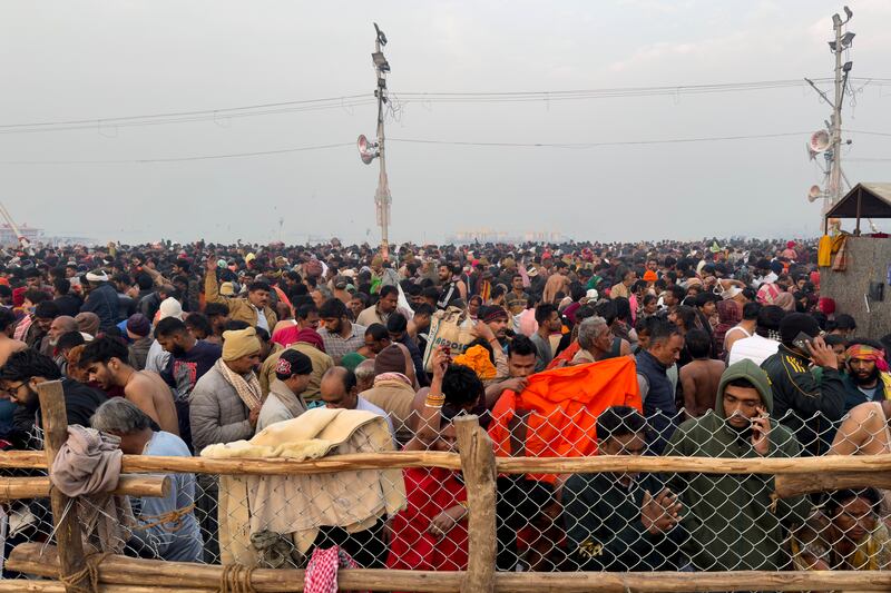 Hindu devotees gather to take a holy dip in the Sangam on Wednesday (Rajesh Kumar Singh/AP)