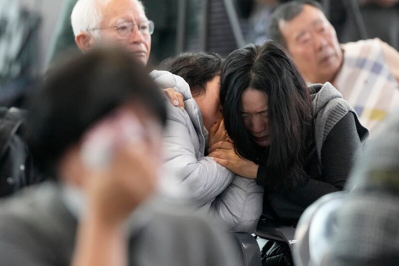 Grieving relatives gather at Muan International Airport in South Korea after Sunday’s crash (Ahn Young-joon/AP)