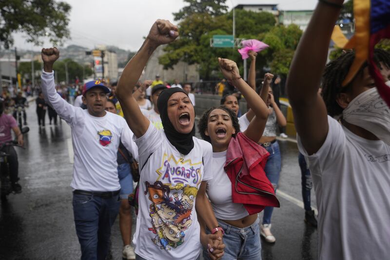 People protest the official election results declaring President Nicolas Maduro the winner of the presidential election, the day after the vote in Caracas (Fernando Vergara/AP)