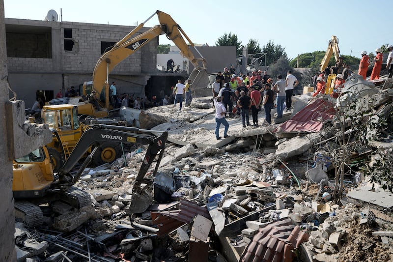 Emergency workers arrive at the scene of an Israeli airstrike in the town of Maisara, north of Beirut, on Wednesday (Bilal Hussein/AP)