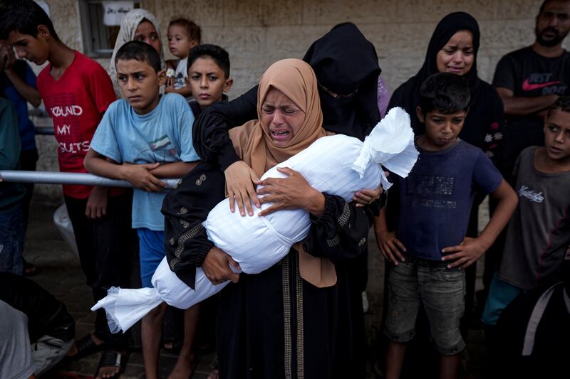 A woman mourns her child at a hospital in Deir al-Balah (Abdel Kareem Hana/AP)