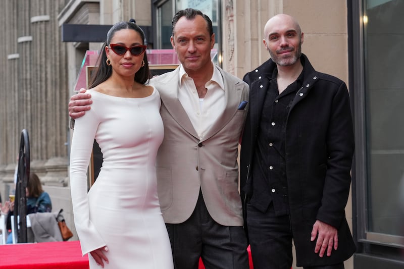 Jurnee Smollett, from left, Jude Law, and David Lowery pose with Law’s new star at a ceremony honouring him on the Hollywood Walk of Fame (Jordan Strauss/Invision/AP)