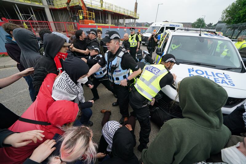 There were scuffles between the campaigners and police outside the factory