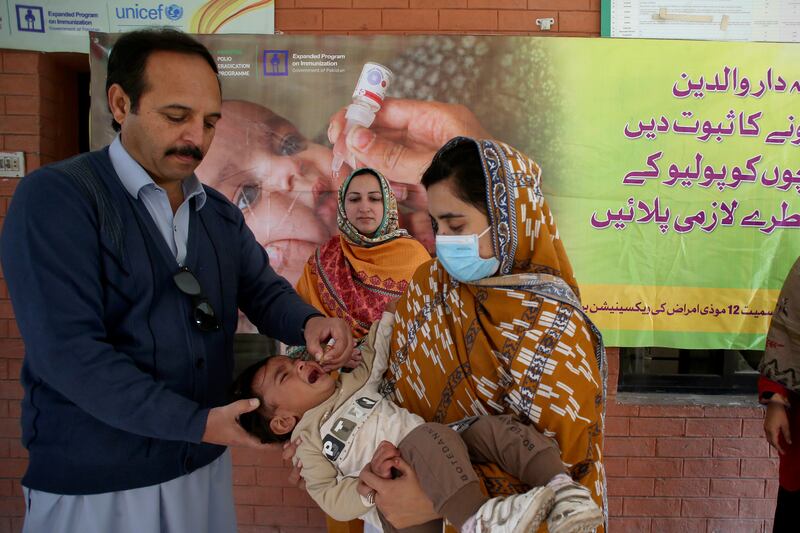 A health worker administers a polio vaccine to a child at a health centre in Peshawar, Pakistan (Muhammad Sajjad/AP)