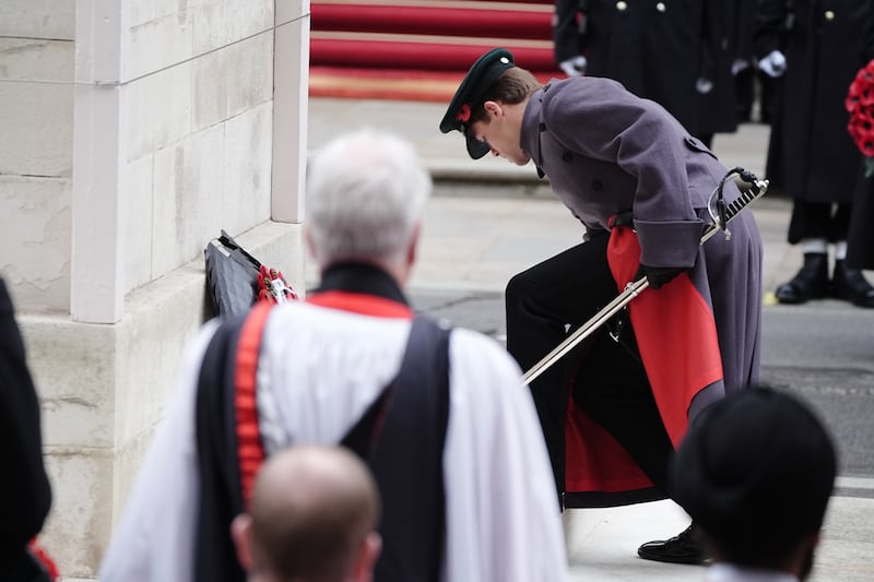 The Queen’s equerry Major Ollie Plunket lays her wreath during the Remembrance Sunday service at the Cenotaph