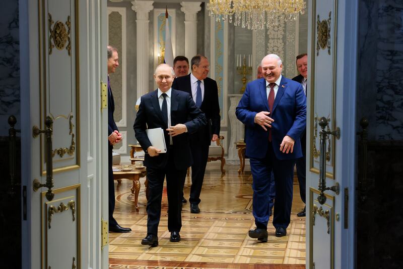 Vladimir Putin and Alexander Lukashenko walk after their talks at the Palace of Independence in Minsk (Mikhail Metzel, Sputnik, Kremlin Pool Photo via AP)