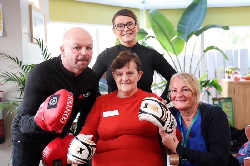 Boxing coach Joe Harvey and wife Mary at Giboney House care home in east Belfast where they deliver a weekly boxing exercice class pictured resident Margaret Bowes and her careworker daughter Caroline.  PICTURE: MAL MCCANN