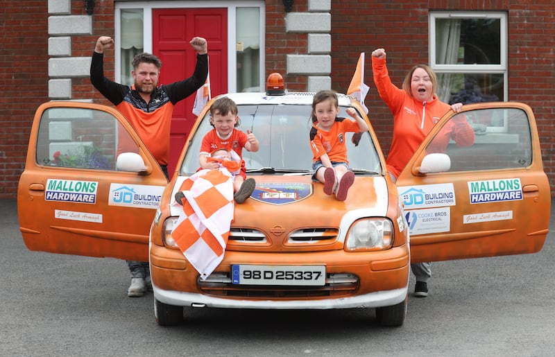 Armagh Fans Johnny Mullan with his sister Jayne , and children Patrick and Bonnie , The Mullan family painted a car for the All Ireland.
PICTURE COLM LENAGHAN