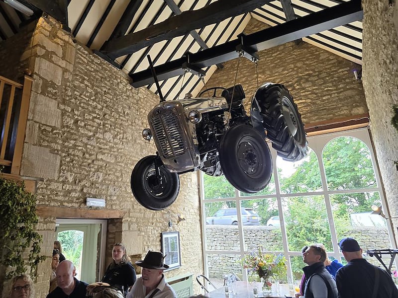 A vintage tractor hangs from the ceiling of the pub (Neil Robinson/PA