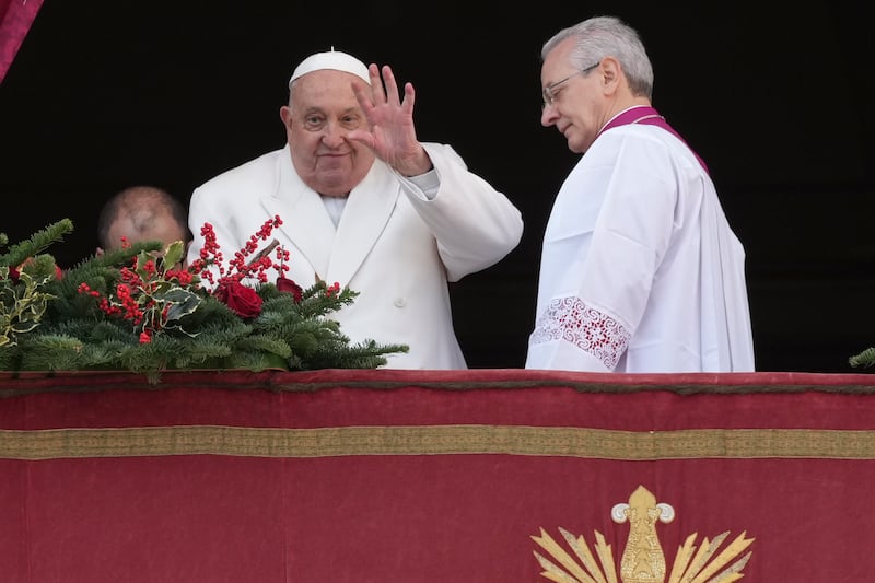 Pope Francis waves before delivering the Urbi et Orbi (Latin for ‘To the city and to the world’) Christmas Day blessing from the main balcony of St Peter’s Basilica (Andrew Medichini/AP)