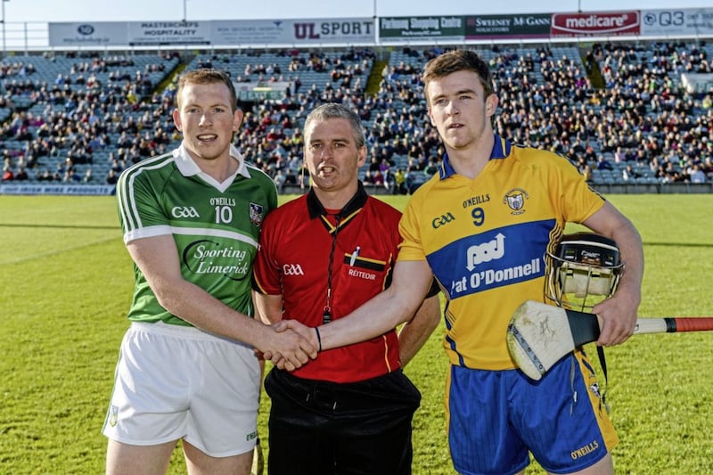 4 June 2014; Limerick captain Shane Dowling and Clare captain Tony Kelly exchange a handshake before the game, in the company of referee Johnny Ryan. Bord Gais Energy Munster GAA Hurling Under 21 Championship Quarter-Final, Limerick v Clare, Gaelic Grounds, Limerick. Picture credit: Diarmuid Greene / SPORTSFILE *** NO REPRODUCTION FEE ***. 