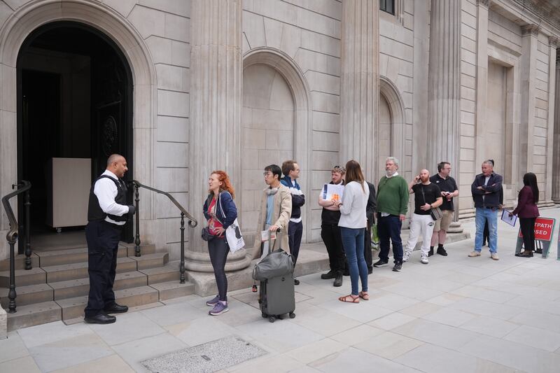 People queue outside the Bank of England, London, on the day the new banknotes featuring the King’s portrait were being issued