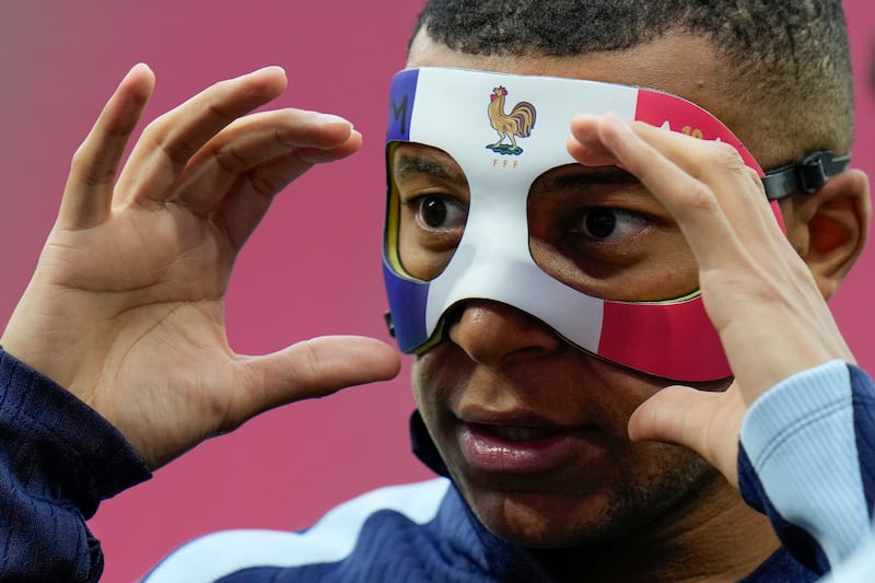 Mbappe is determined to play against Poland despite a broken nose (Hassan Ammar/AP)