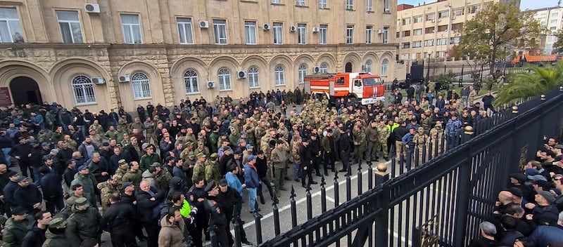 Protesters gather outside the parliament building of the Georgian separatist region of Abkhazia as tensions flared over a proposed pact that would allow Russians to buy apartments in the region (AP)