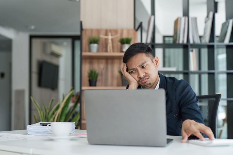 Burnt out man struggling to focus in an in office