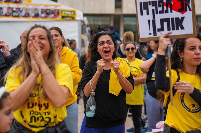 Relatives and friends of Israeli people killed and abducted by Hamas and taken into Gaza react as they follow the news of the hostages’ release in Tel Aviv (Ariel Schalit/AP)