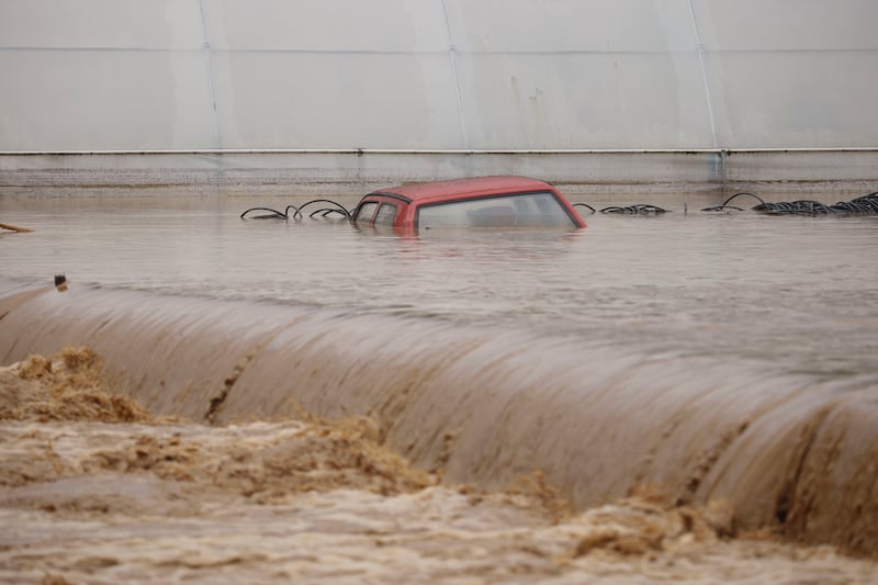 A car is submerged in floodwaters outside an apartment building in the village of Kiseljak, northern Bosnia (Armin Durgut/AP)