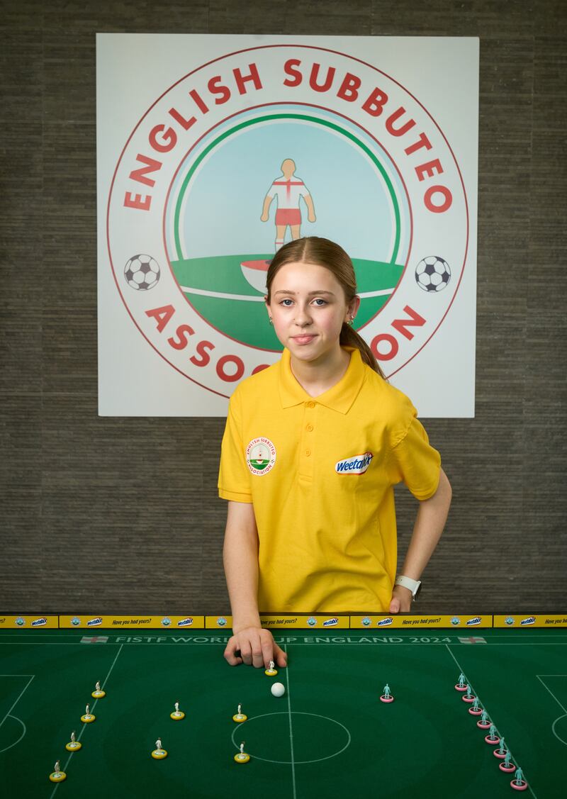 Ruby Matthews from Flintshire, Wales, plays the tabletop game in which players use miniature footballers to flick a ball around a table