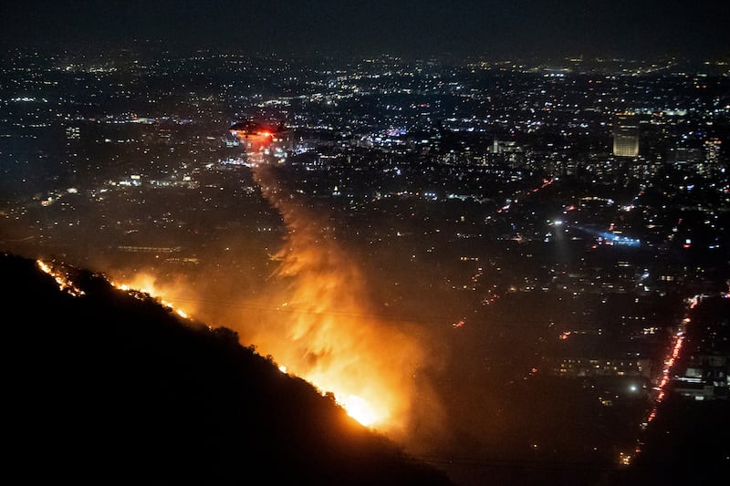 Water is dropped by helicopter on the burning Sunset Fire in the Hollywood Hills (Ethan Swope/AP)