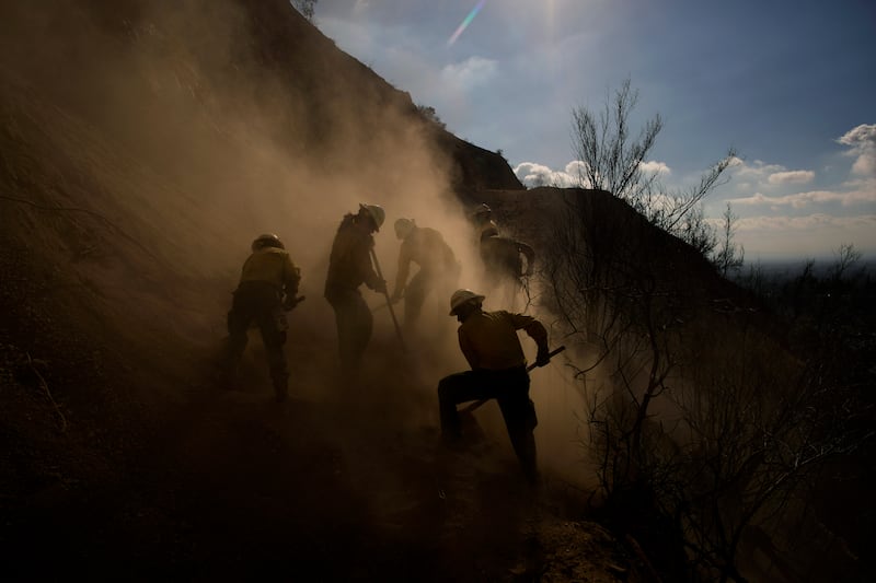 Members of the Navajo Scouts firefighter crew kick up dust (John Locher/AP)