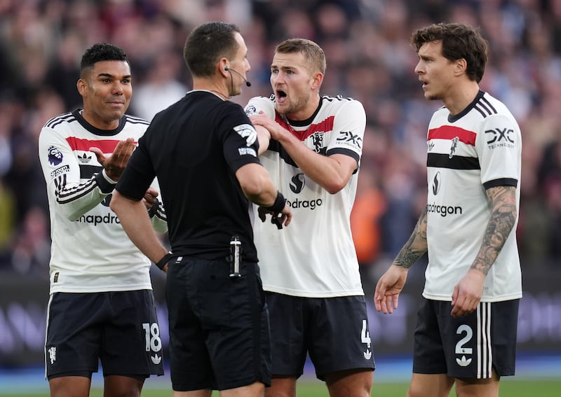 Manchester United’s Matthijs de Ligt (centre right) protests to referee David Coote (centre left) after he awarded a penalty to West Ham