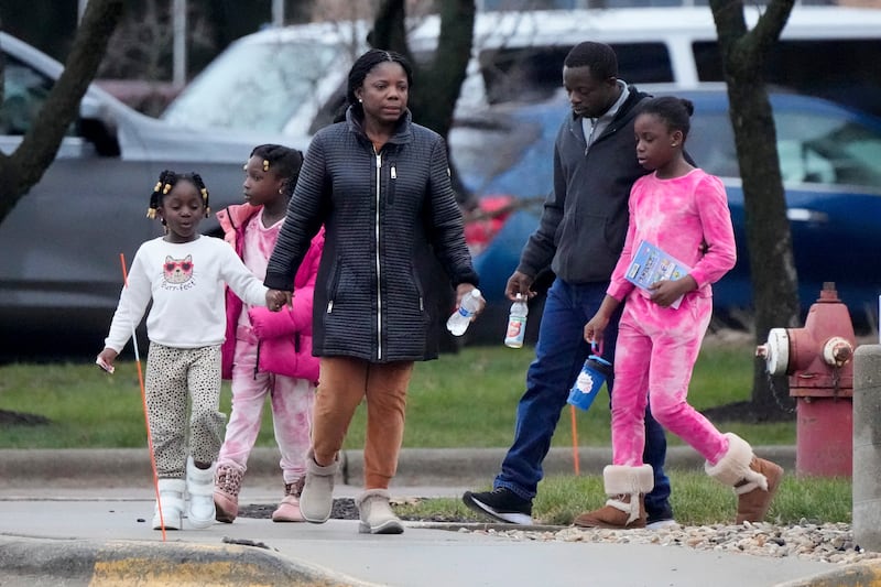 A family leaves the reunification centre (Morry Gash/AP)