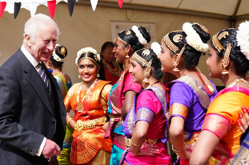 The King speaks to performers as he attends a celebration at Edinburgh Castle