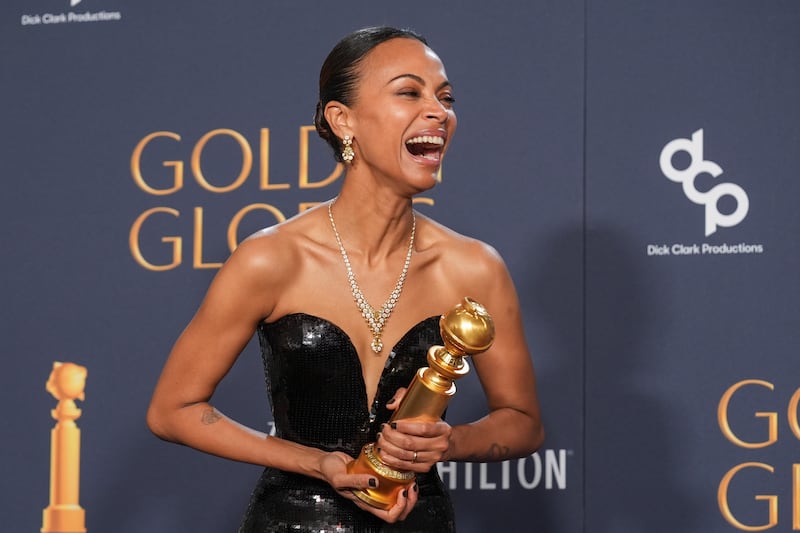 Zoe Saldana poses in the press room with the award for best performance by a female actor in a supporting role in any motion picture for Emilia Perez (Chris Pizzello/AP)